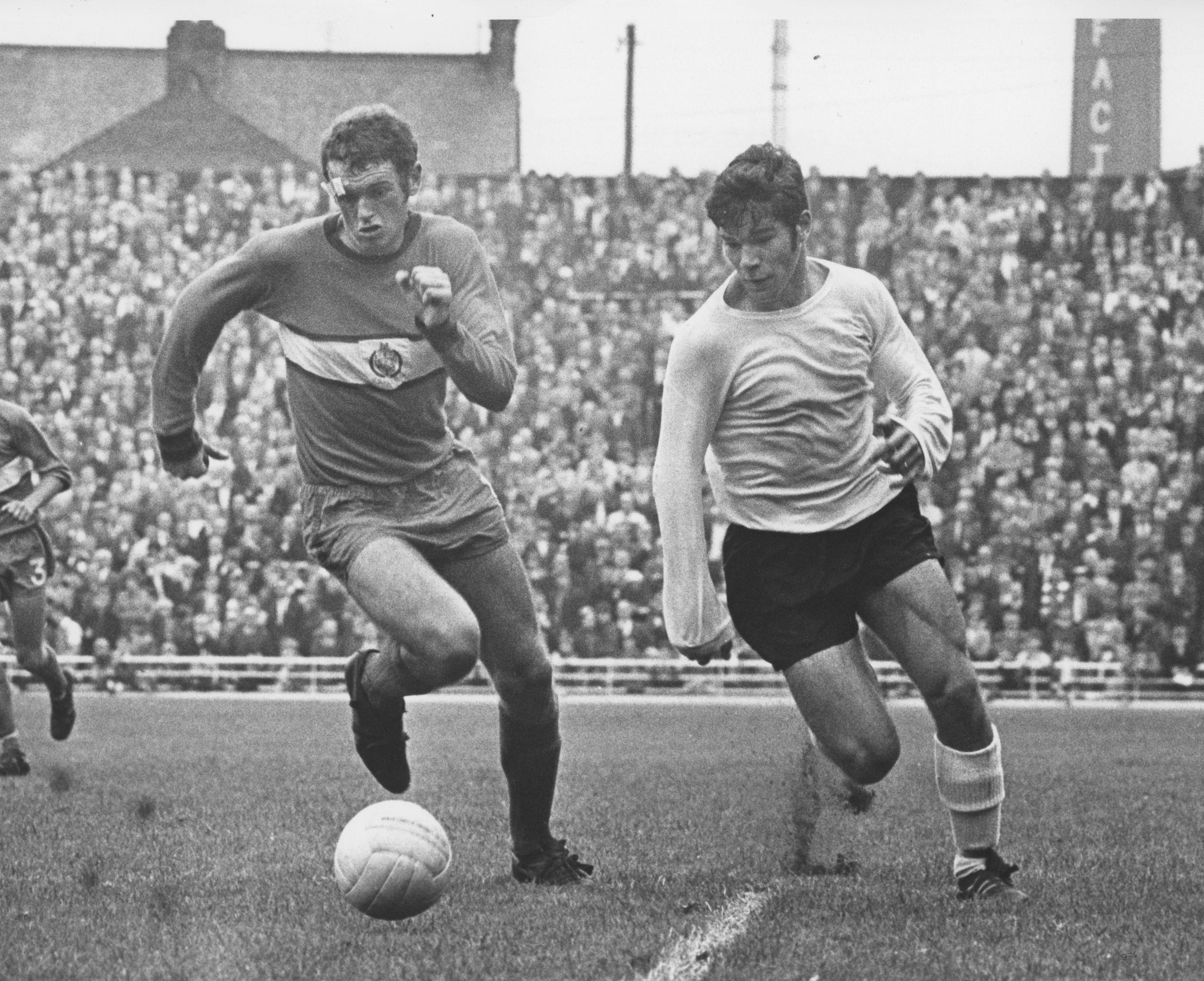 Malcolm Macdonald goes round the Stockport defender