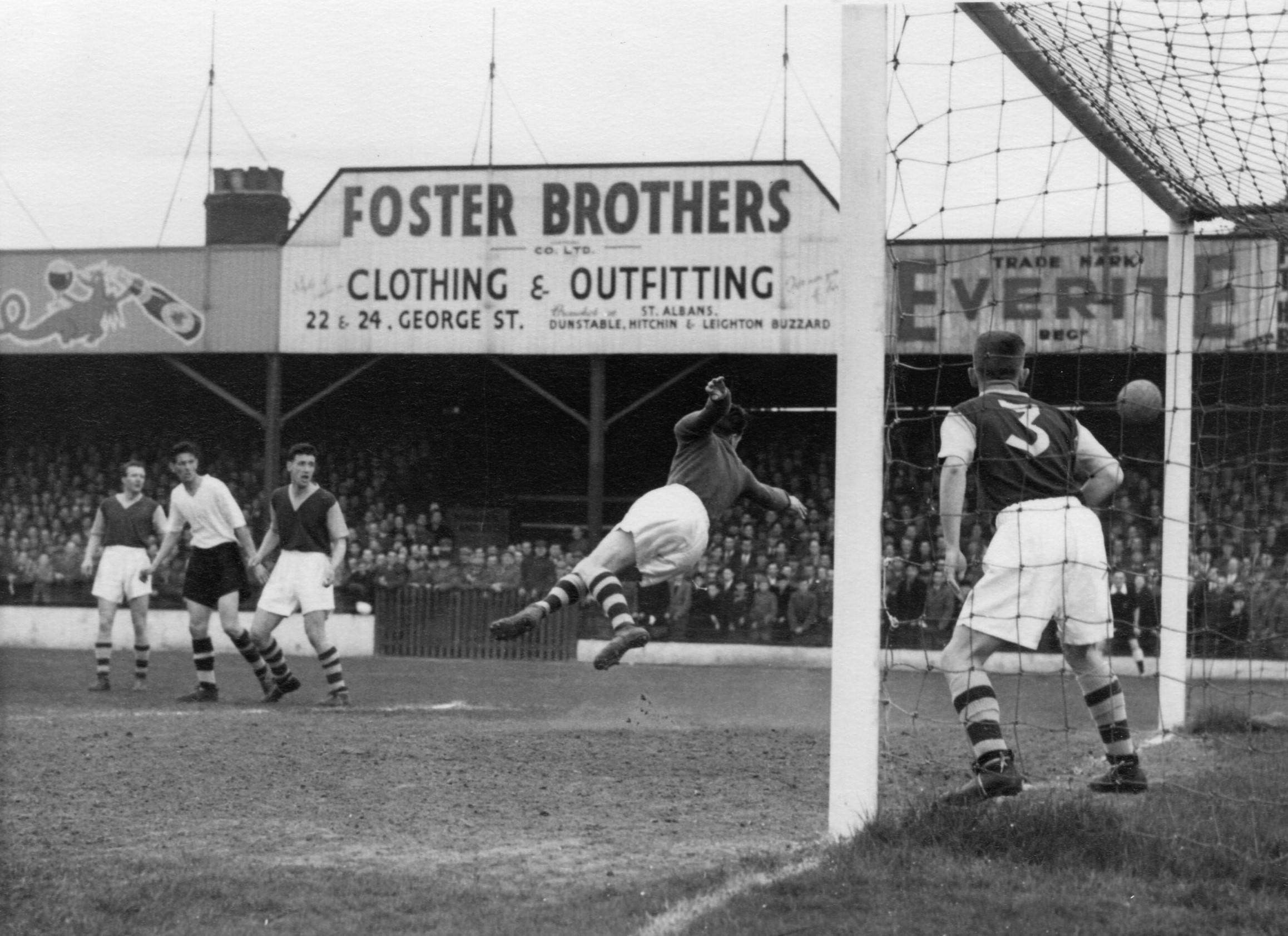 John Groves looks on as Burnley keeper Colin McDonald tips a shot on goal around the post